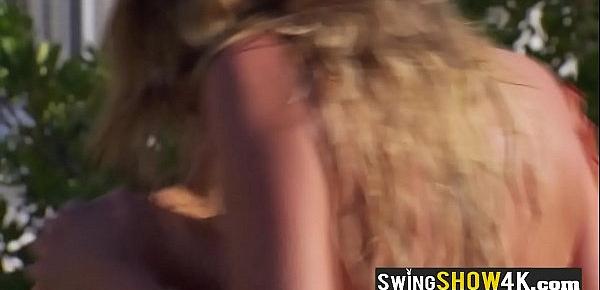  Topless swinger babes are playing softcore sex games outdoors.